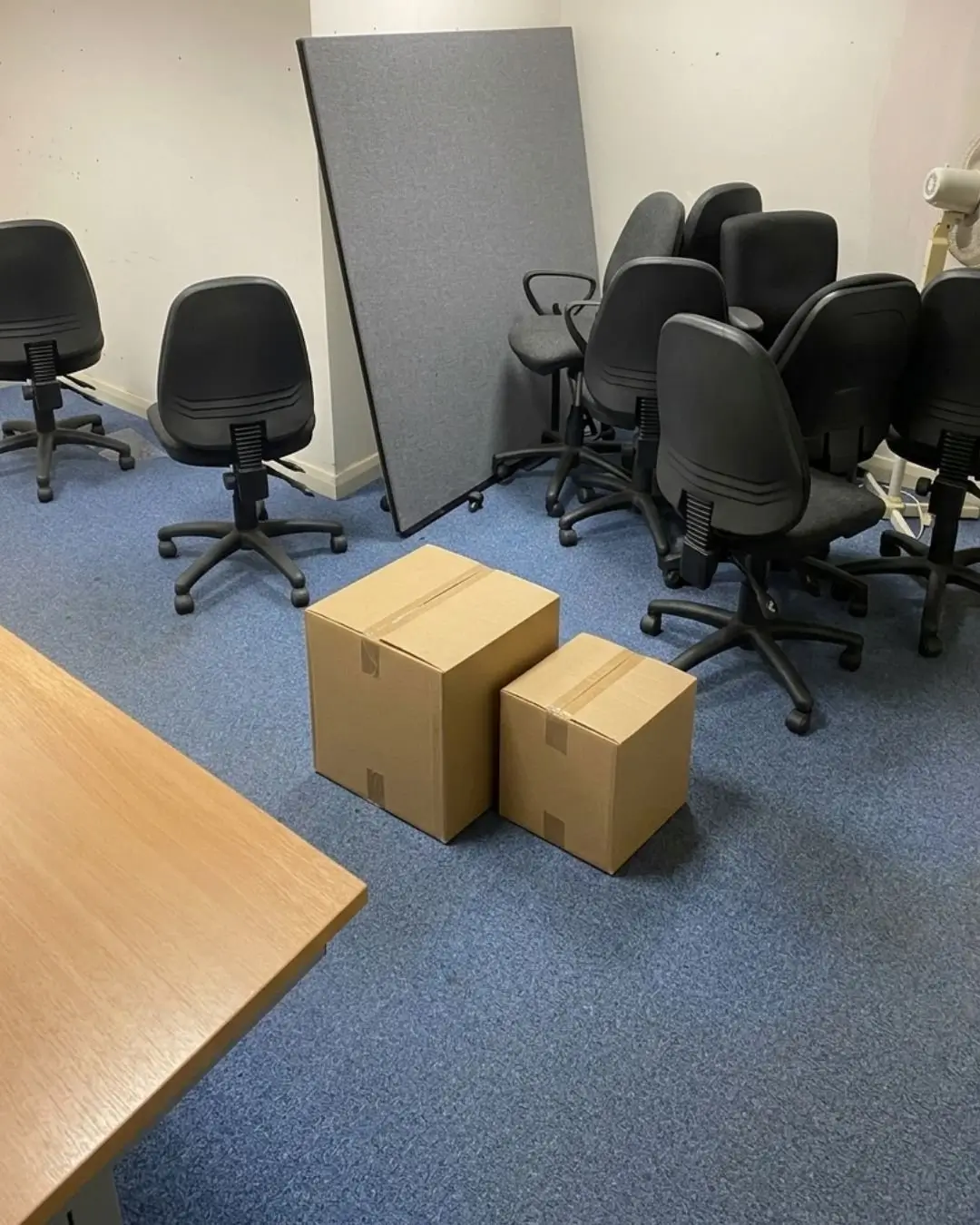 Our Work Office clearance setup with office chairs, packed cardboard boxes, and furniture ready for removal.
